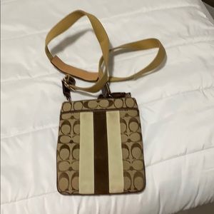Coach tan crossbody bag with zipper pocket on back